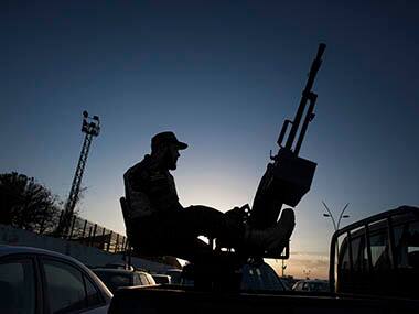 A Libyan army soldier stands guard sitting on an antiaircraft truck during the handover of the Nawaseen military compound, which was the headquarters of Libyan militias, in Souk al-Juma district, Tripoli, Libya, Thursday, Nov. 21, 2013. Militias from a string of Libyan cities left the capital, Tripoli, on Thursday, nearly a week after militiamen killed more than 40 people protesting their presence in the city. The withdrawal is a triumph for the residents of Tripoli, who on Nov. 15 held a mass protest against the militias, which have fueled lawlessness nationwide since the 2011 fall of longtime dictator Moammar Gadhafi. AP