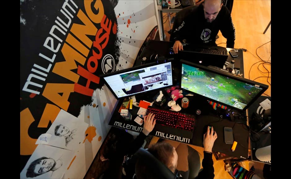 Millenium eSport professional gamers look at theirs computer screens as they play inside the Millenium Gaming House in Marseille November 12, 2013. The Millenium Gaming House, which opened its doors in Marseille in 2011, is the most important French e-sport organization and houses pro gamers who live, game, eat and sleep full-time in the building. The house is dedicated to the training of Pro Gamers teams for International competitions. Players train long hours to master the difficulties and subtleties of only one game and participate in Lan-Parties around the world. E-Sports earnings has ranked the 100 players with the highest overall earnings from competitive gaming, with over 60 gamers who have earned over $100,000 in prize money. Picture taken November 12, 2013. REUTERS/Jean-Paul Pelissier 