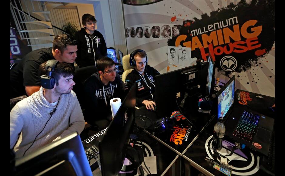 Millenium eSport professional gamers look at a computer screen as they play inside the Millenium Gaming House in Marseille November 13, 2013. The Millenium Gaming House, which opened its doors in Marseille in 2011, is the most important French e-sport organization and houses pro gamers who live, game, eat and sleep full-time in the building. The house is dedicated to the training of Pro Gamers teams for International competitions. Players train long hours to master the difficulties and subtleties of only one game and participate in Lan-Parties around the world. E-Sports earnings has ranked the 100 players with the highest overall earnings from competitive gaming, with over 60 gamers who have earned over $100,000 in prize money. Picture taken November 13, 2013. REUTERS/Jean-Paul Pelissier 