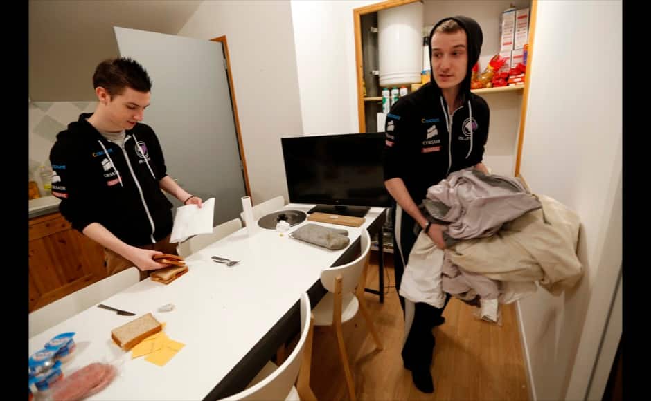 Millenium eSport professional gamer Clement of France (L), nicknamed Riskin, prepares to eat as team mate Tony, nicknamed ShLaYa, puts away sheets inside the kitchen of the Millenium Gaming House in Marseille November 12, 2013. The Millenium Gaming House, which opened its doors in Marseille in 2011, is the most important French e-sport organization and houses pro gamers who live, game, eat and sleep full-time in the building. The house is dedicated to the training of Pro Gamers teams for International competitions. Players train long hours to master the difficulties and subtleties of only one game and participate in Lan-Parties around the world. E-Sports earnings has ranked the 100 players with the highest overall earnings from competitive gaming, with over 60 gamers who have earned over $100,000 in prize money. Picture taken November 12, 2013. REUTERS/Jean-Paul Pelissier 