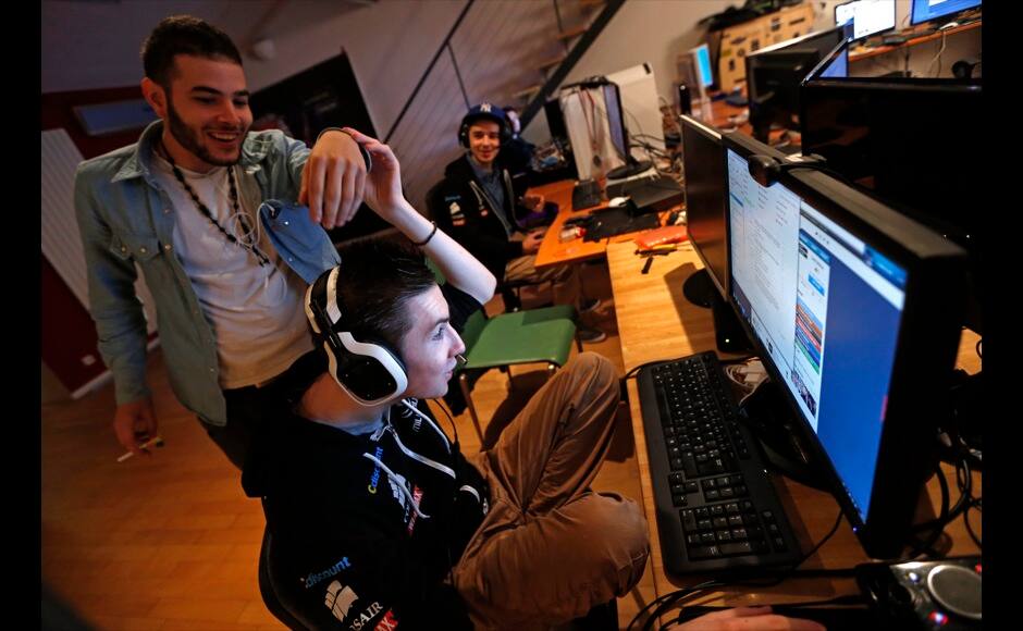 Millenium eSport professional gamer Samir of France, nicknamed D1abloZeTank, (L) jokes with Clement, nicknamed Riskin, inside the Millenium Gaming House in Marseille November 13, 2013. The Millenium Gaming House, which opened its doors in Marseille in 2011, is the most important French e-sport organization and houses pro gamers who live, game, eat and sleep full-time in the building. The house is dedicated to the training of Pro Gamers teams for International competitions. Players train long hours to master the difficulties and subtleties of only one game and participate in Lan-Parties around the world. E-Sports earnings has ranked the 100 players with the highest overall earnings from competitive gaming, with over 60 gamers who have earned over $100,000 in prize money. Picture taken November 13, 2013. REUTERS/Jean-Paul Pelissier 