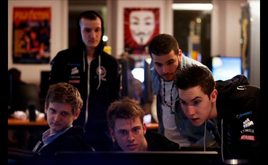 Millenium eSport professional gamers look at a computer screen as they play inside the Millenium Gaming House in Marseille November 13, 2013. The Millenium Gaming House, which opened its doors in Marseille in 2011, is the most important French e-sport organization and houses pro gamers who live, game, eat and sleep full-time in the building. The house is dedicated to the training of Pro Gamers teams for International competitions. Players train long hours to master the difficulties and subtleties of only one game and participate in Lan-Parties around the world. E-Sports earnings has ranked the 100 players with the highest overall earnings from competitive gaming, with over 60 gamers who have earned over $100,000 in prize money. Picture taken November 13, 2013. REUTERS/Jean-Paul Pelissier 