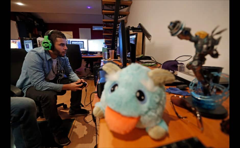 Millenium eSport professional gamer Samir of France, nicknamed D1abloZeTank, looks at a computer screen as he plays inside the Millenium Gaming House in Marseille Novembre 13, 2013. The Millenium Gaming House, which opened its doors in Marseille in 2011, is the most important French e-sport organization and houses pro gamers who live, game, eat and sleep full-time in the building. The house is dedicated to the training of Pro Gamers teams for International competitions. Players train long hours to master the difficulties and subtleties of only one game and participate in Lan-Parties around the world. E-Sports earnings has ranked the 100 players with the highest overall earnings from competitive gaming, with over 60 gamers who have earned over $100,000 in prize money. Picture taken November 13, 2013. REUTERS/Jean-Paul Pelissier 