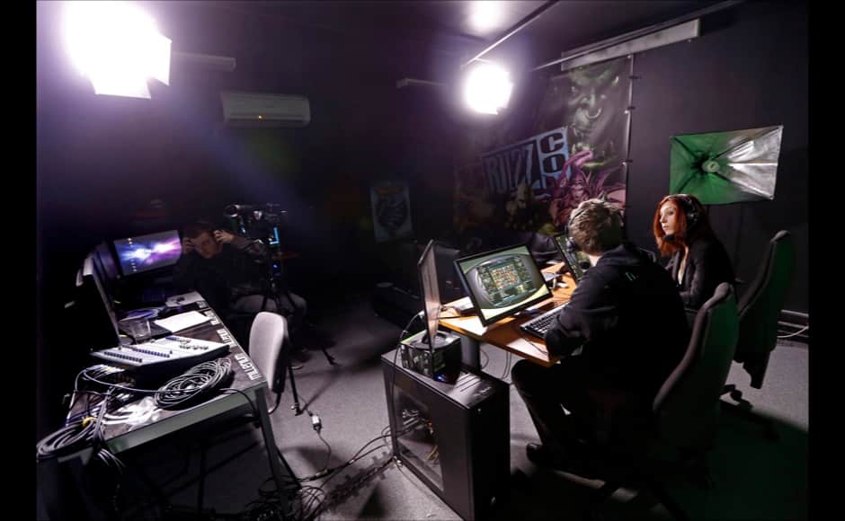 Millenium TV commentators Jeffrey and Isabelle talk about a game session inside the Millenium Gaming House in Marseille November 13, 2013. The Millenium Gaming House, which opened its doors in Marseille in 2011, is the most important French e-sport organization and houses pro gamers who live, game, eat and sleep full-time in the building. The house is dedicated to the training of Pro Gamers teams for International competitions. Players train long hours to master the difficulties and subtleties of only one game and participate in Lan-Parties around the world. E-Sports earnings has ranked the 100 players with the highest overall earnings from competitive gaming, with over 60 gamers who have earned over $100,000 in prize money. Picture taken November 13, 2013. REUTERS/Jean-Paul Pelissier 