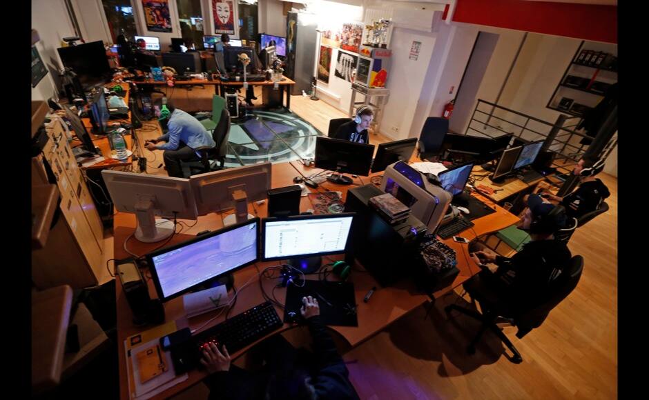 Millenium eSport professionnal gamers look at their computer screens as they play inside the Millenium Gaming House in Marseille November 13, 2013. The Millenium Gaming House, which opened its doors in Marseille in 2011, is the most important French e-sport organization and houses pro gamers who live, game, eat and sleep full-time in the building. The house is dedicated to the training of Pro Gamers teams for International competitions. Players train long hours to master the difficulties and subtleties of only one game and participate in Lan-Parties around the world. E-Sports earnings has ranked the 100 players with the highest overall earnings from competitive gaming, with over 60 gamers who have earned over $100,000 in prize money. Picture taken November 13, 2013. REUTERS/Jean-Paul Pelissier 