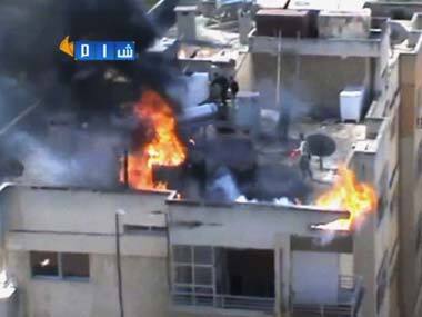 A building on fire after shelling in Homs. AP