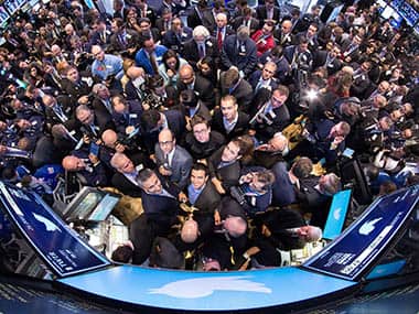 In this photo provided by the New York Stock Exchange, the New York Stock Exchange trading floor is crowded with traders and journalists on the morning of Twitter's public stock debut, Thursday, Nov. 7, 2013 in New York. Twitter set a price of $26 per share for its initial public offering on Wednesday evening and will begin trading Thursday under the ticker symbol 