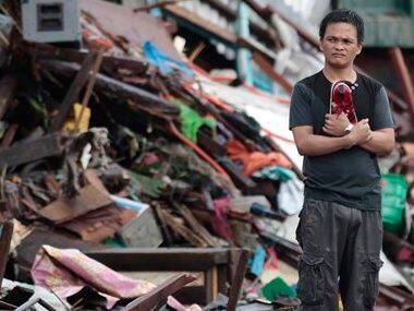 A resident looks at houses damaged by typhoon Haiyan. AP