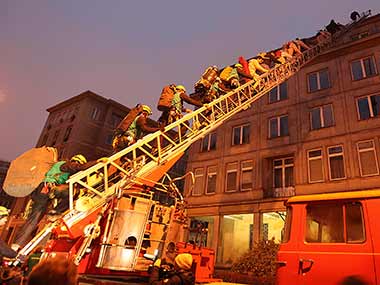 Climate change activists climb the roof top of a building in Poland. AP