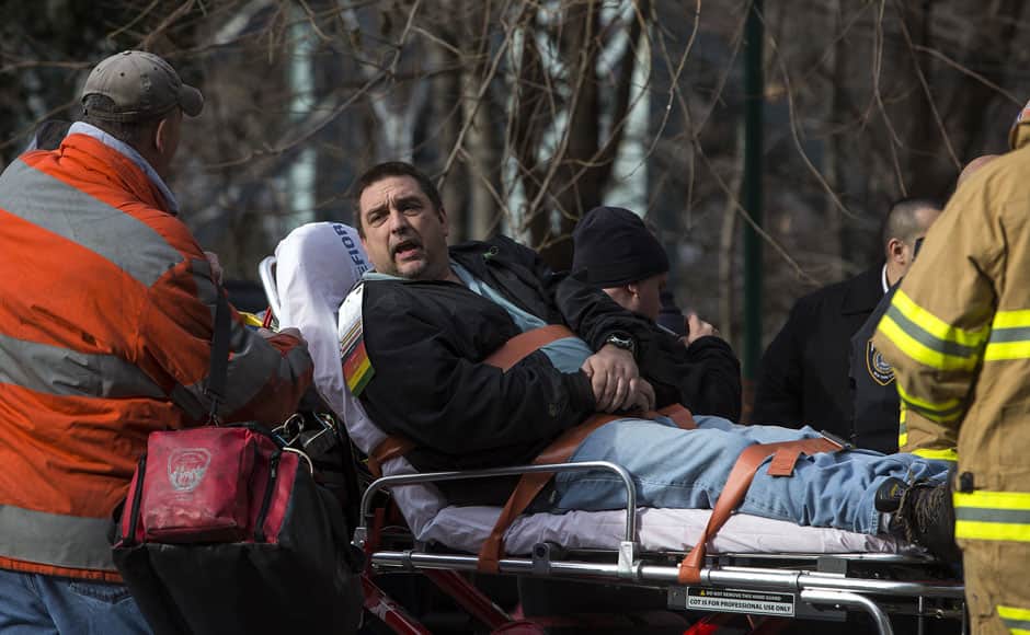 Metro-North engineer William Rockefeller Jr. is loaded into an ambulance after a train derailment in the Bronx borough of New York December 1, 2013. A suburban New York train derailed on Sunday, killing four people and injuring 70, including 11 critically, when all seven cars of a Metro-North train ran off the tracks on a sharp curve, officials said. REUTERS