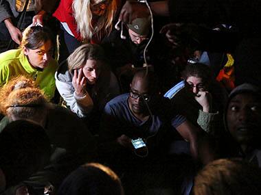 People listen to a radio as South African President Jacob Zuma announces the death of former South African President Nelson Mandela in Houghton, December 5, 2013. Mandela died peacefully at his Johannesburg home on Thursday after a prolonged lung infection, Zuma said. Mandela, the country's first black president and anti-apartheid icon known in South Africa by his clan name of Madiba, emerged from 27 years in apartheid prisons to help guide South Africa through bloodshed and turmoil to democracy. Reuters