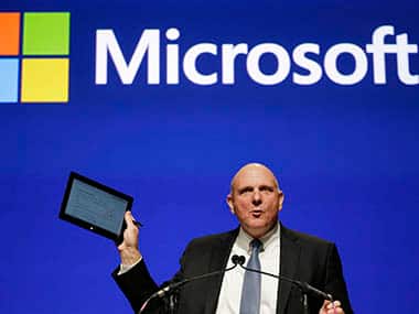 Microsoft CEO Steve Ballmer holds up his personal tablet device as he speaks at the company’s annual shareholders meeting. AP 