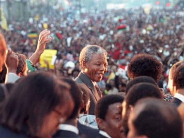 Nelson Mandela is all smiles as he is greeted by tens of thousands of people in Harlem, New York's famous black district, in this 1990 file photo. Reuters