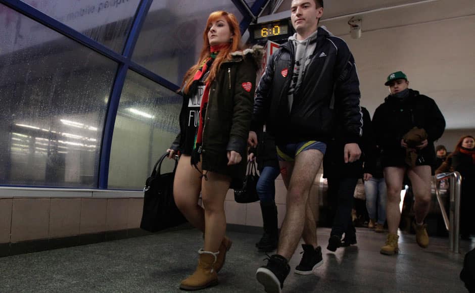 Passengers with no pants exit a subway station during the 