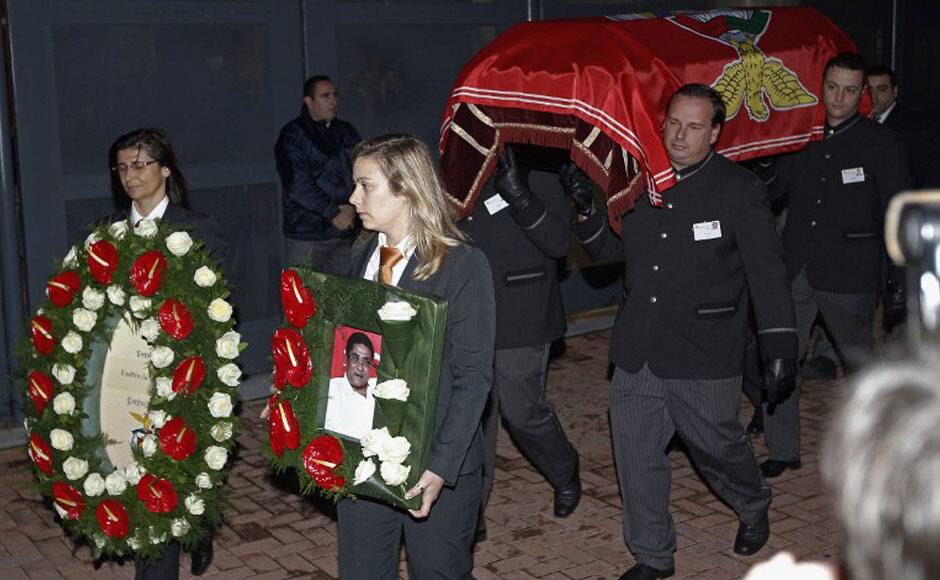 A woman carries a picture of late Portuguese football player Eusebio da Silva Ferreira, also known as the 