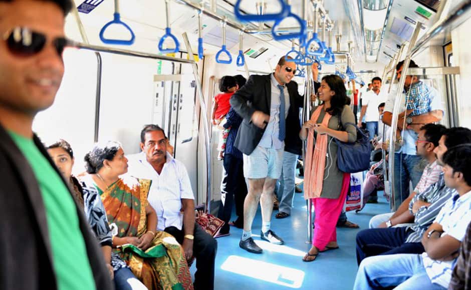 An Indian commuter, stripped to his underpants, chats to a fellow commuter as he takes part in a No Pants Subway Ride on the metro in Bangalore on January 12, 2014. The No Pants Subway Ride is an annual event staged across major cities of the World every January. The mission started as a small prank with seven guys and has grown into an international celebration of silliness, with dozens of cities around the world participating each year. The idea behind No Pants is simple - random passengers board a subway car at separate stops in the middle of winter without pants. AFP