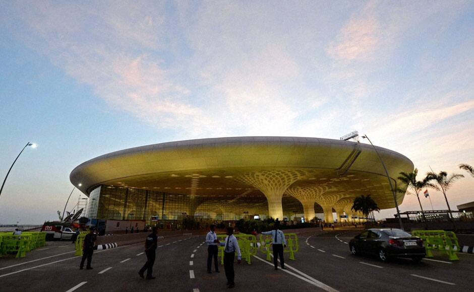 Security stand guard outside the Chhatrapati Shivaji International Airport's Terminal 2 that was inaugurated by Prime Minister Manmohan Singh in Mumbai on Friday. PTI 