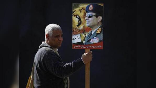 Gunmen kill Egyptian general; ousted Mursi defiant at trial