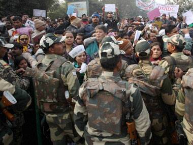 Security personnel trying to control crowd during Delhi Chief Minister Arvind Kejriwal's inaugural 'Janata Darbar'. PTI
