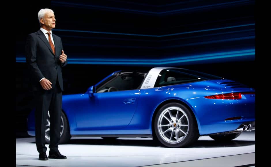 Porsche President and CEO Matthias Muller speaks next to a Porsche 911 Targa at its introduction during the press preview day of the North American International Auto Show in Detroit, Michigan January 13, 2014. REUTERS