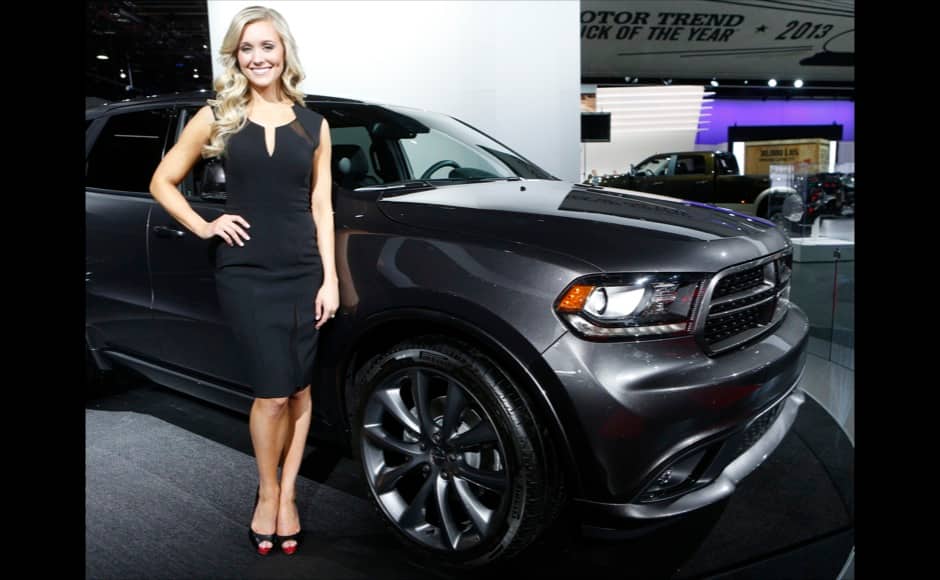 Model Erin Wolak poses next to a 2014 Dodge Durango during the press preview day of the North American International Auto Show in Detroit, Michigan January 14, 2014. REUTERS