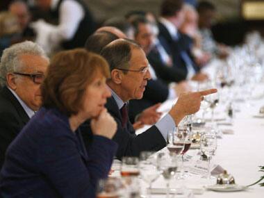Russian Foreign Minister Sergei Lavrov gestures as EU foreign policy chief Catherine Ashton and UN-Arab League envoy for Syria Lakhdar Brahimi sit beside him during a break at the Geneva II peace talks dedicated to the ongoing conflict in Syria. AFP
