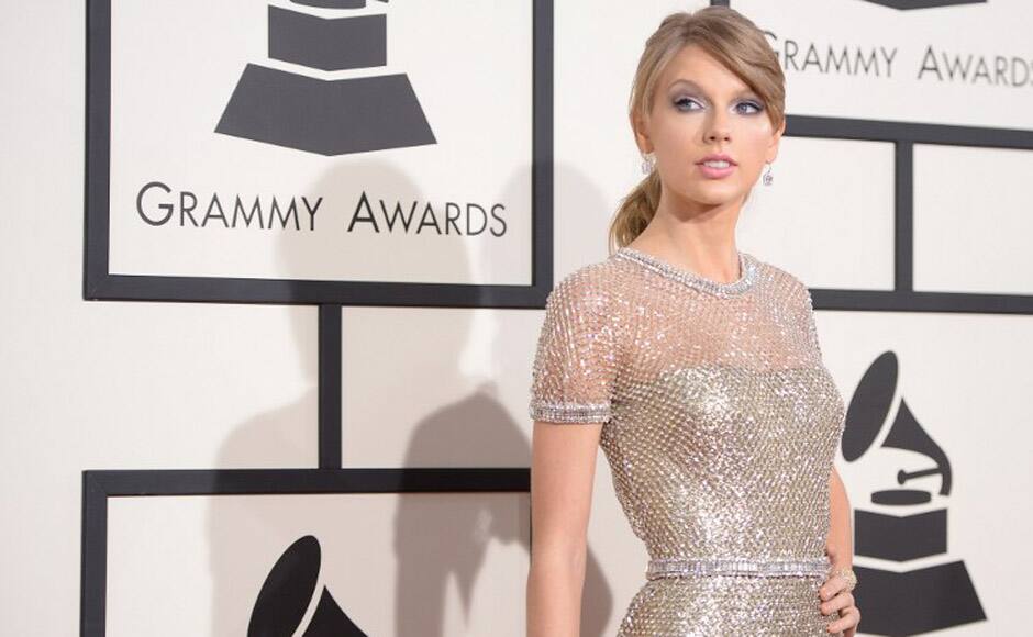 Singer Taylor Swift wore glimmering Gucci with a clinging gold dress hugging her tiny frame with a sparkling silver mesh overlay. AFP image