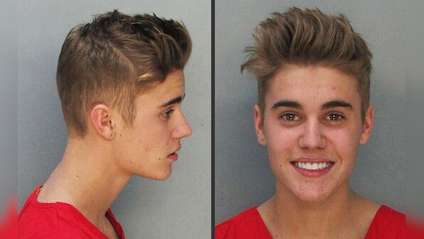 Photos: Justin Bieber smiles for police mug shots at Miami  