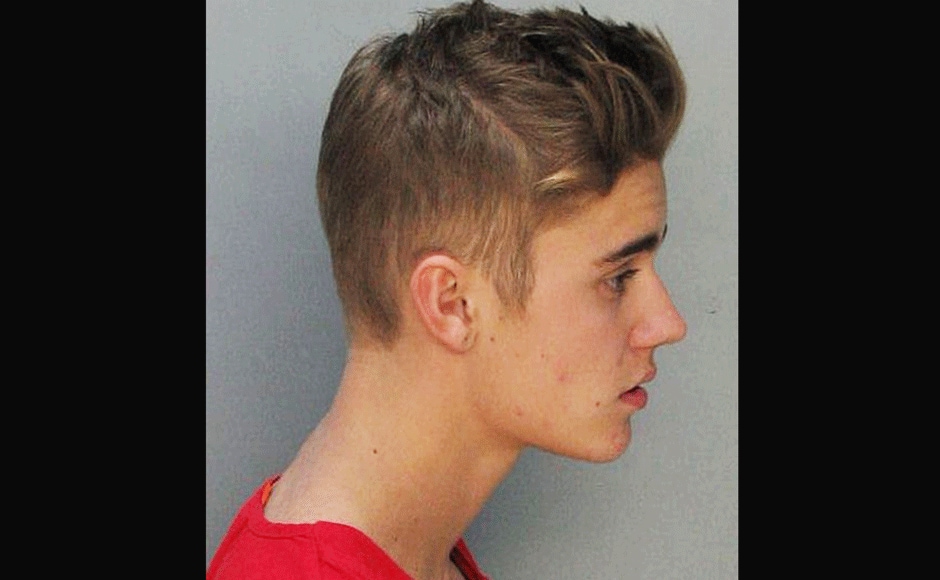 This police booking mug made available by the Miami Dade County Corrections Department shows pop star Justin Bieber, Thursday, Jan. 23, 2014. Bieber and singer Khalil were arrested for allegedly drag-racing on a Miami Beach Street. AP