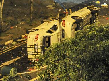 Vehicles lie overturned following the riots. AFP.