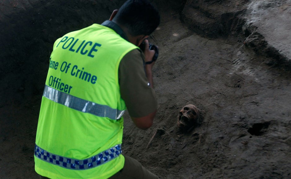 A police officer takes a picture of a human skull at a construction site in the former war zone in Mannar, about 327 km (203 miles) from the capital Colombo. Reuters A police officer takes a picture of a human skull at a construction site in the former war zone in Mannar, about 327 km (203 miles) from the capital Colombo. Reuters