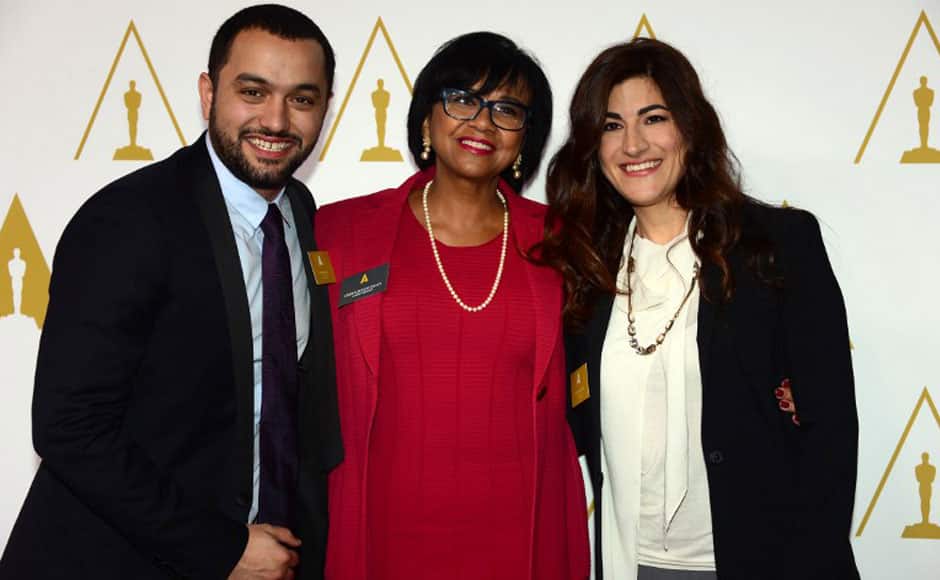 Karim Amer (L) and Jehane Noujaim (R) pose with Academy Prrsident Cheryl Boone Isaacs on arrival for the 86th Oscar's Nominee's Luncheon at the Beverly Hilton Hotel in Beverly Hills, California, on February 10, 2014. AFP
