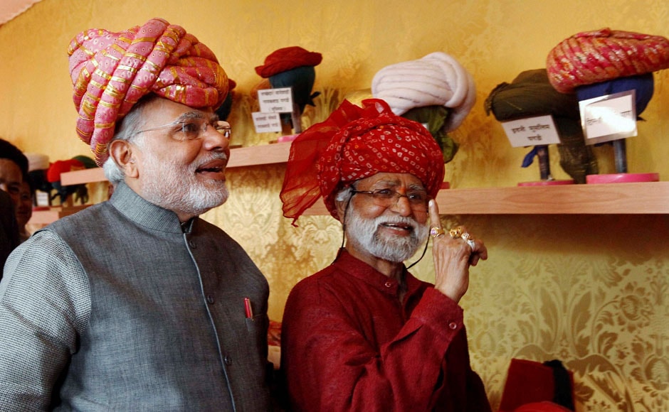 Gujarat Chief Minister and BJP's PM candidate Narendra Modi wears a traditional Gujarati turban at a stall during inauguration of five-day long handicraft exhibition in Ahmedabad on Friday. PTI Gujarat Chief Minister and BJP's PM candidate Narendra Modi wears a traditional Gujarati turban at a stall during inauguration of five-day long handicraft exhibition in Ahmedabad on Friday. PTI
