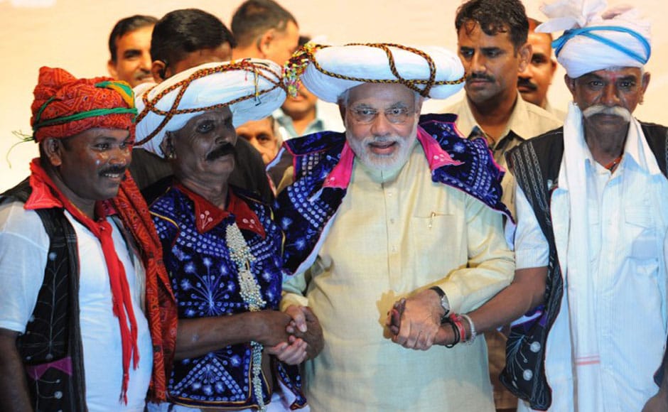 Narendra Modi (C), poses for a photo with supporters at his 64th birthday at the Town Hall in Gandhinagar, some 30 kms from Ahmedabad. AFP Narendra Modi (C), poses for a photo with supporters at his 64th birthday at the Town Hall in Gandhinagar, some 30 kms from Ahmedabad. AFP