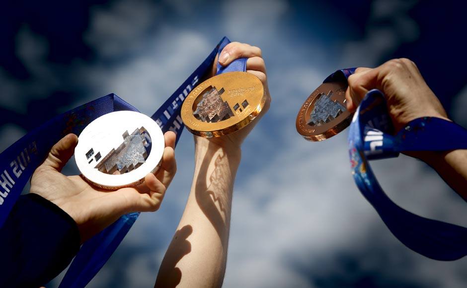 Gus Kenworthy, Joss Christensen and Nick Goepper of the USA Skiing team display their medals in the Olympic Park (This image was processed using digital filters). Getty Images