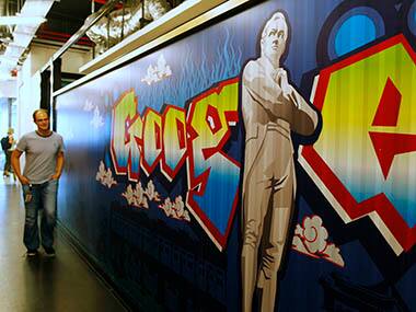 Google's communications manager Moroney stands next to a Google logo of Singapore's founder Raffles in their Singapore office. Reuters