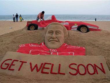 A sculpture of Michael Schumacher titled Get Well Soon by sand artist Sudarshan Patnaik at a beach in Puri: AP