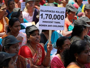A demonstrator holds a placard during a protest against Sri Lanka’s President Rajapaksa in Mumbai. Reuters