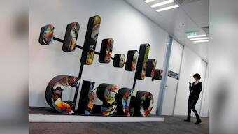 Cisco profits halve, revenue declines in second quarter