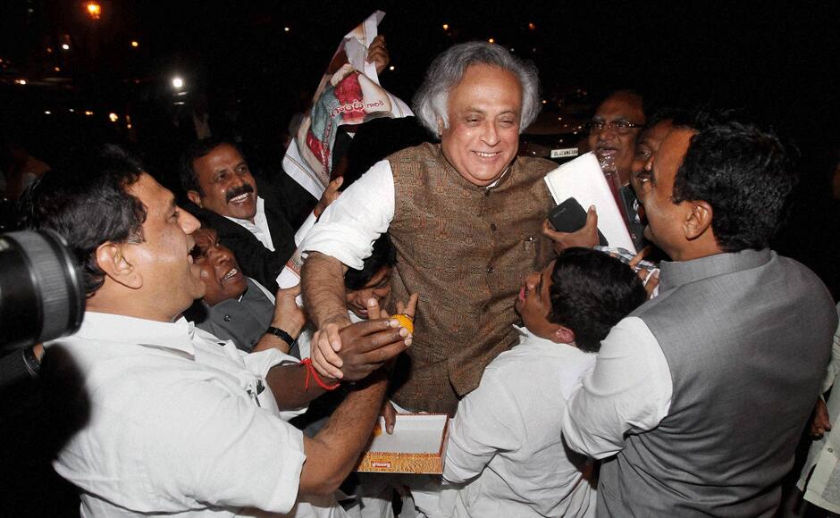Rural Development Minister Jairam Ramesh is lifted by pro-Telangana leaders after the passage of Telangana Bill in the Rajya Sabha in New Delhi on Thursday. PTI