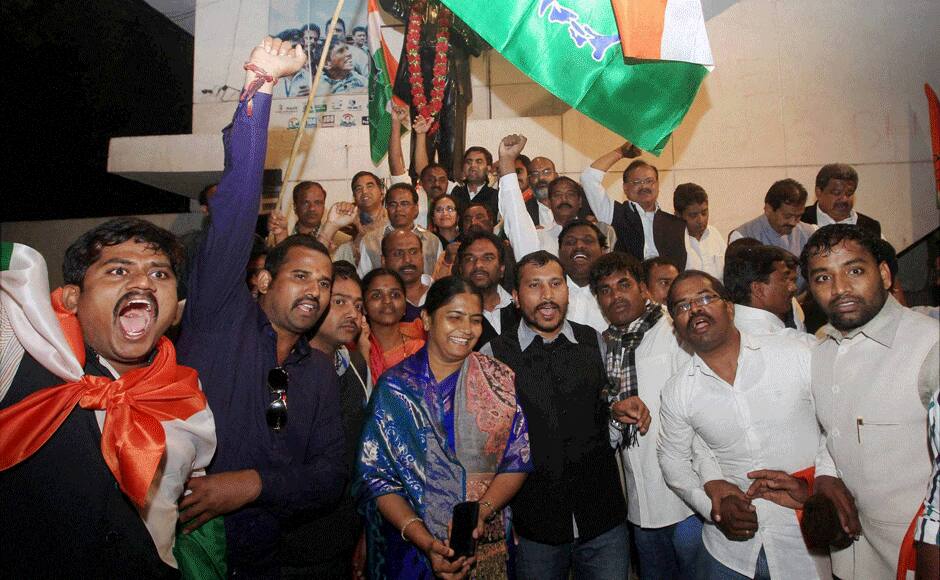 Congress workers celebrate after the passage of Telangana Bill in the Rajya Sabha, at Andhra Bhavan in New Delhi on Thursday. PTI 