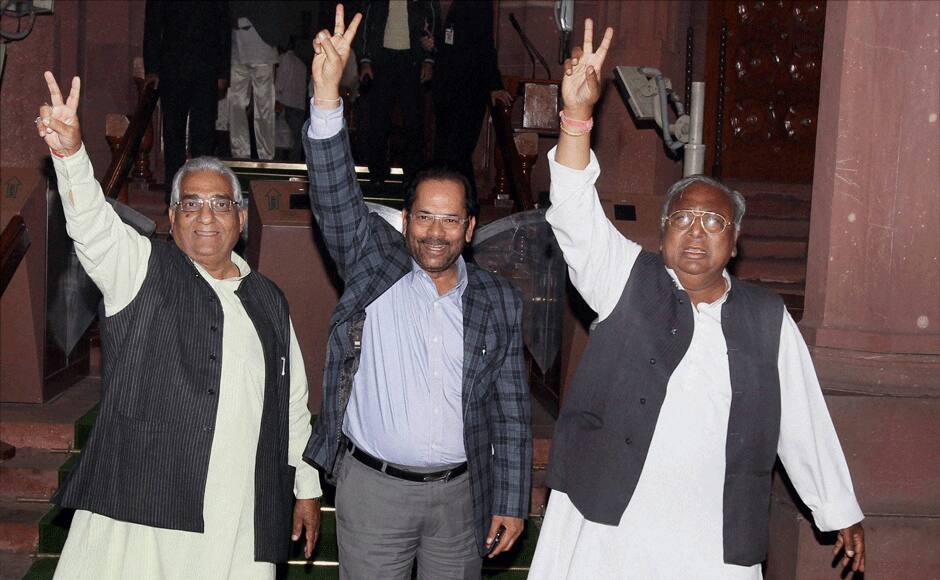  Hanumantharao and Mukhtar Abbas Naqvi flash victory sign after the passage of Telangana Bill in the Rajya Sabha in New Delhi on Thursday. PTI