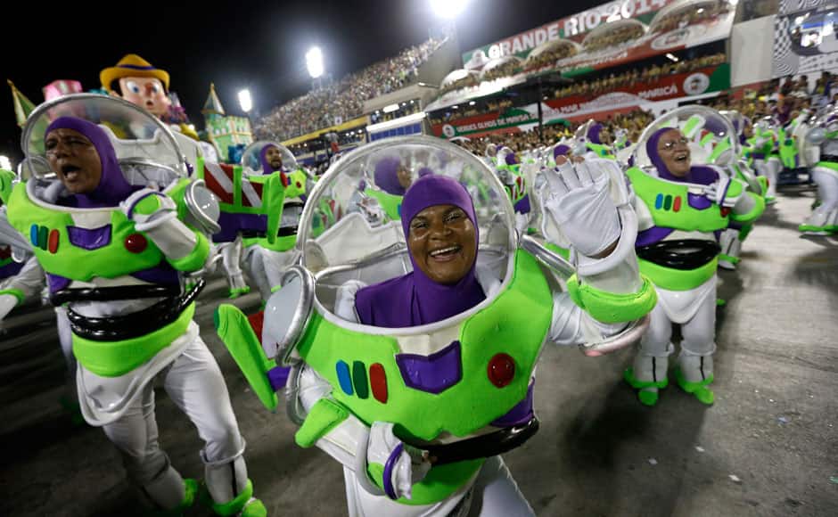 Performers from the Uniao da Ilha do Governador samba school parade during carnival celebrations at the Sambadrome in Rio de Janeiro, Brazil, early Tuesday, March 4, 2014. Brazil's Carnival is maintaining its frenetic pace, with hundreds of roving parties taking over Rio de Janeiro's streets and famed samba school parades heading into their final night. AP 