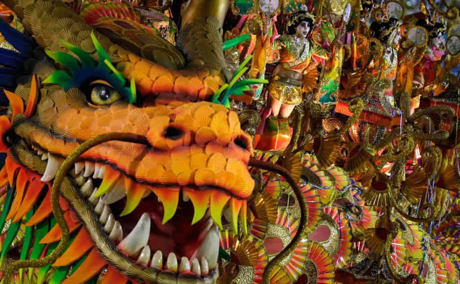 Performers from the Beija Flor samba school parade on a float during carnival celebrations at the Sambadrome in Rio de Janeiro, Brazil, Monday, March 3, 2014. AP 