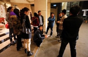 Chinese relatives of passengers aboard a missing Malaysia Airlines plane wait outside a hotel in Beijing Sunday. AP