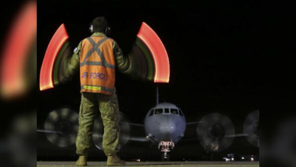 Search for flight MH370 will go on, promises Australian PM Abbott