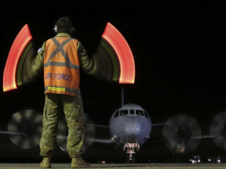 Search for flight MH370 will go on, promises Australian PM Abbott