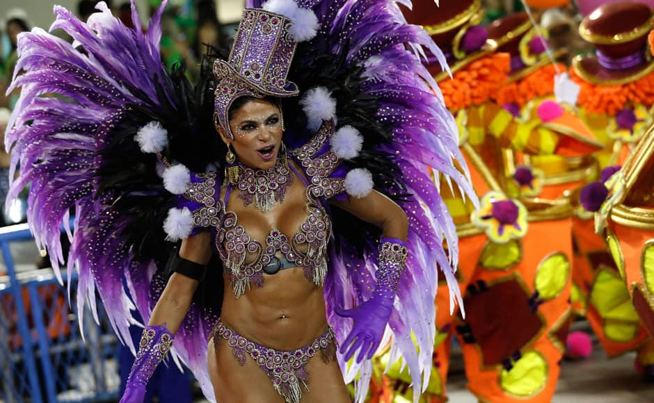 A performer from the Uniao da Ilha do Governador samba school parades during carnival celebrations at the Sambadrome in Rio de Janeiro, Brazil, early Tuesday, March 4, 2014. Brazil's Carnival is maintaining its frenetic pace, with hundreds of roving parties taking over Rio de Janeiro's streets and famed samba school parades heading into their final night. AP 