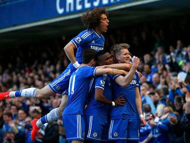Chelsea's Andre Schurrle celebrates with team mates after scoring a goal against Arsenal during their English Premier League soccer match at Stamford Bridge in London March 22, 2014. Reuters 