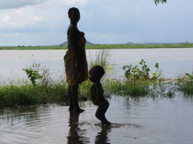 In this file photo provided by UNICEF a woman and child wade in flood waters in Mutarara, Mozambique in the Tete district. AP 